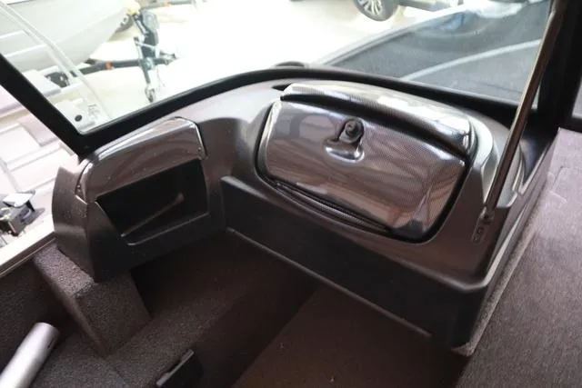 Slide: The Image of 2025 Lowe FM 1775 WT boat interior dashboard with storage compartments. - 4