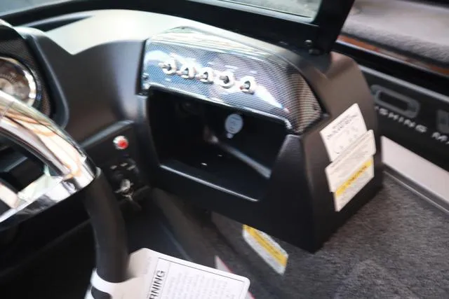 Slide: The Image of 2025 Lowe FM 1775 WT boat dashboard with open glove compartment and steering wheel. - 6