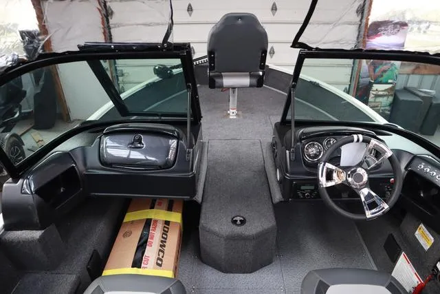 Slide: The Image of 2025 Lowe FM 1775 WT boat interior with dual consoles and steering wheel. - 10