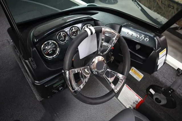 Slide: The Image of 2025 Lowe FM 1775 WT boat dashboard with chrome steering wheel and instrument panel. - 11