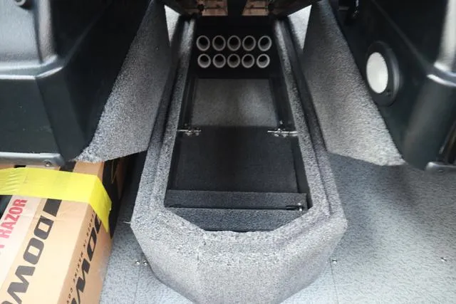 Slide: The Image of 2025 Lowe FM 1775 WT boat interior storage compartment with rod holders. - 13