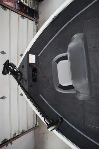 Slide: The Image of 2025 Lowe FM 1775 WT boat interior with gray seating and trolling motor. - 14