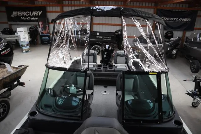 Slide: The Image of 2025 Lowe FM 1775 WT boat with clear canopy in showroom. - 16