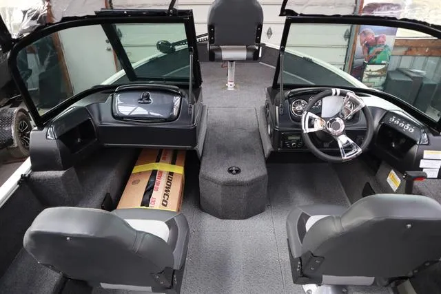 Slide: The Image of 2025 Lowe FM 1775 WT boat interior with dual seats and steering console. - 18