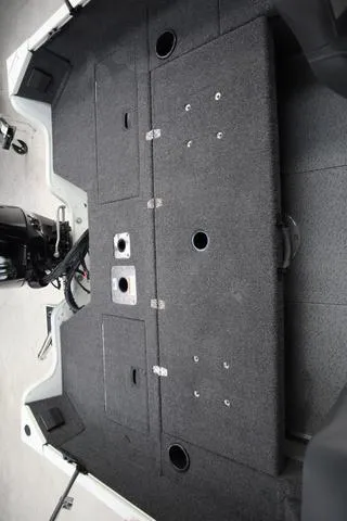 Slide: The Image of 2025 Lowe FM 1775 WT boat interior with carpeted deck and storage compartments. - 20