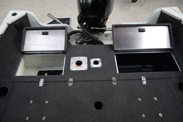 Slide: The Image of 2025 Lowe FM 1775 WT boat interior with storage compartments and motor. - 21