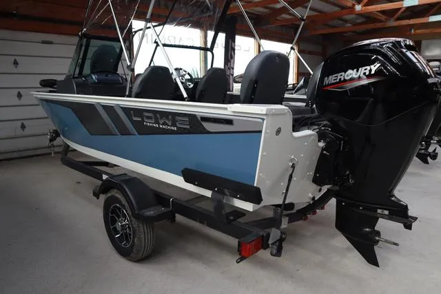 Slide: The Image of 2025 Lowe FM 1775 WT boat with Mercury engine in a garage setting. - 4