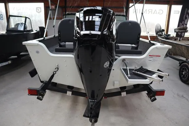 Slide: The Image of 2025 Lowe FM 1775 WT boat with Mercury 115 engine, rear view in showroom. - 9
