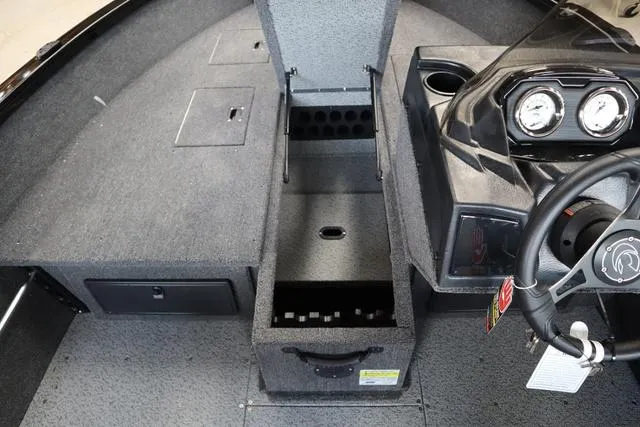 Slide: The Image of 2024 Crestliner 1650 Fish Hawk JS SC boat interior with storage compartments and dashboard. - 4