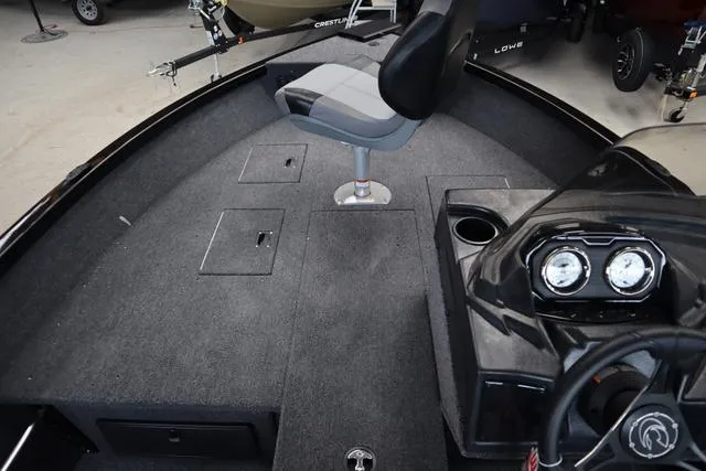 Slide: The Image of 2024 Crestliner 1650 Fish Hawk JS SC boat interior with seating and dashboard. - 8