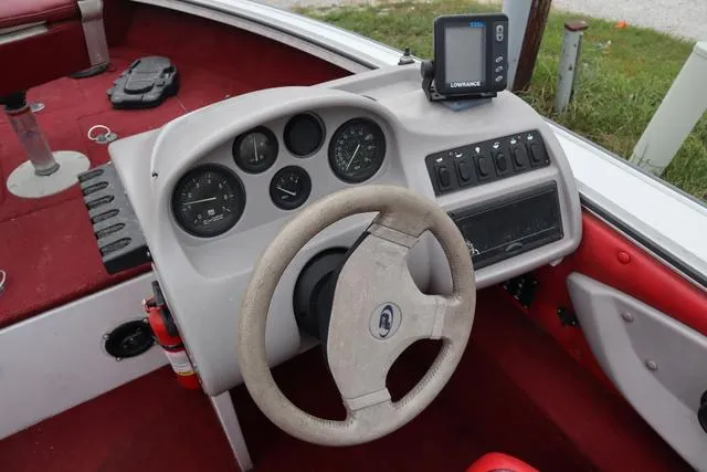 Slide: The Image of 1997 Princecraft 178 boat dashboard with steering wheel and gauges, featuring a Lowrance fish finder. - 3