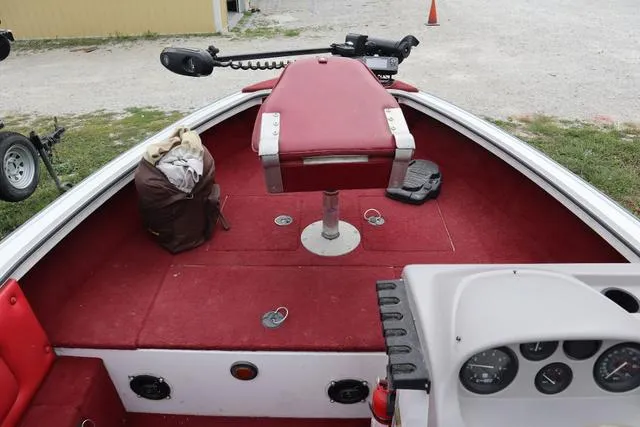 Slide: The Image of 1997 Princecraft 178 boat interior with red carpet and seating, featuring a trolling motor. - 4