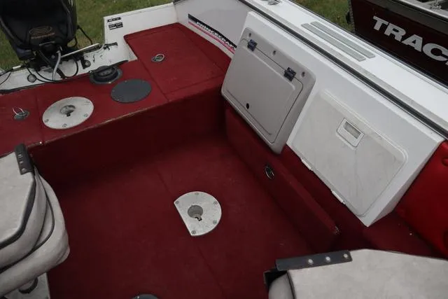 Slide: The Image of Interior of a 1997 Princecraft 178 boat with red carpet and storage compartments. - 5