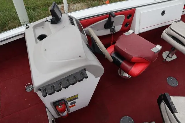 Slide: The Image of Interior of a 1997 Princecraft 178 boat with red seating and steering console. - 7