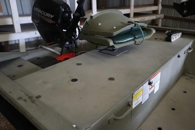 Slide: The Image of 2020 Tracker 1448AW Grizzly boat with Mercury motor in storage. - 3