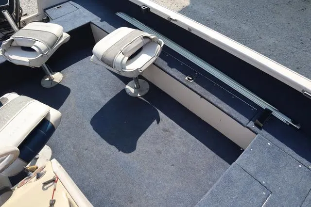 Slide: The Image of 1997 Crestliner 1750 Fish Hawk SC interior with seating and carpeted flooring. - 11