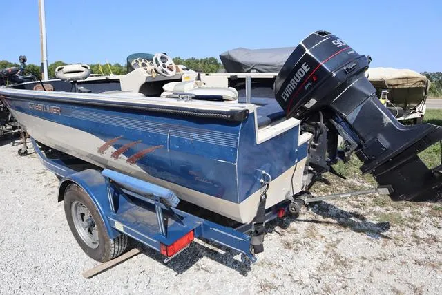 Slide: The Image of 1997 Crestliner 1750 Fish Hawk SC boat with Evinrude motor on trailer. - 3