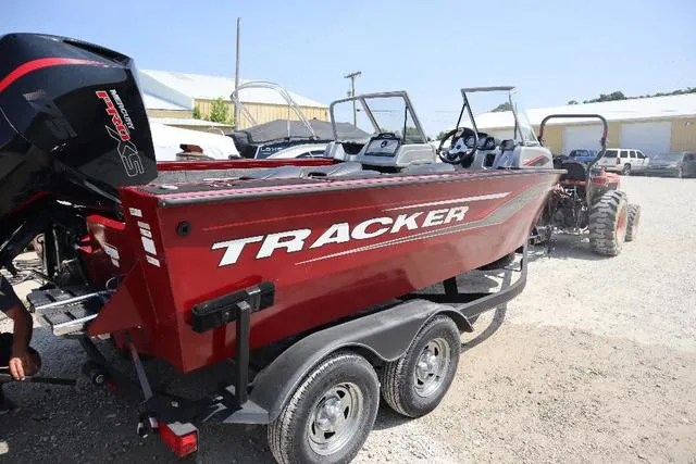 Slide: The Image of 2019 Tracker Targa™ V-18 Combo boat on trailer, red exterior, parked outdoors. - 3