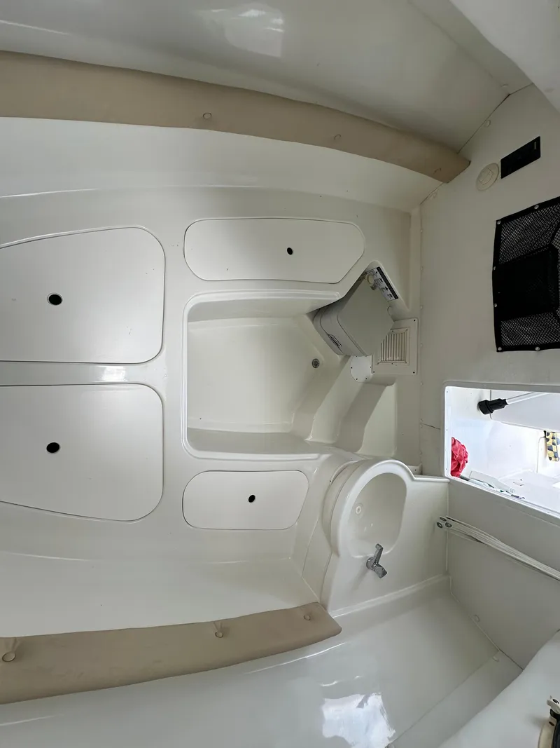 Slide: The Image of Interior of 2008 Pro-Line 26 XP boat, featuring white cabin and seating area. - 10