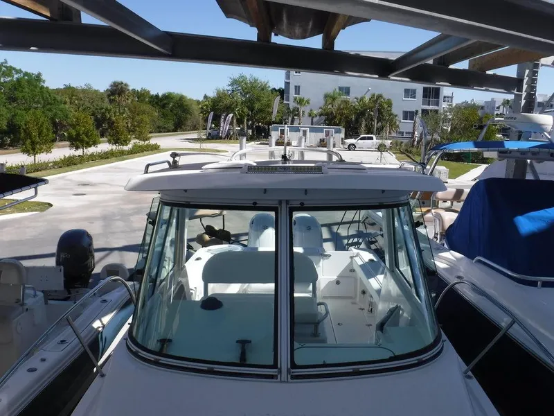 Slide: The Image of 2008 Pro-Line 26 XP boat docked, viewed from above, showcasing cockpit and seating area. - 14