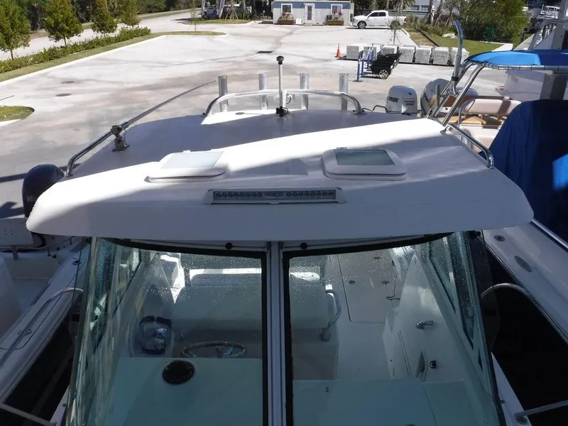 Slide: The Image of 2008 Pro-Line 26 XP boat docked, showcasing cabin and deck features. - 17
