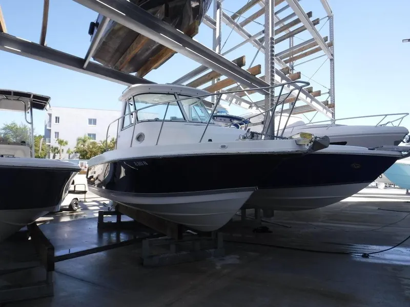 Slide: The Image of 2008 Pro-Line 26 XP boat in storage, featuring a sleek design and sturdy build. - 18