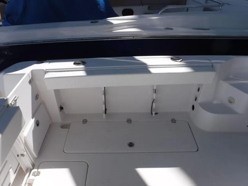 Slide: The Image of 2008 Pro-Line 26 XP boat interior with storage compartments and seating area. - 24