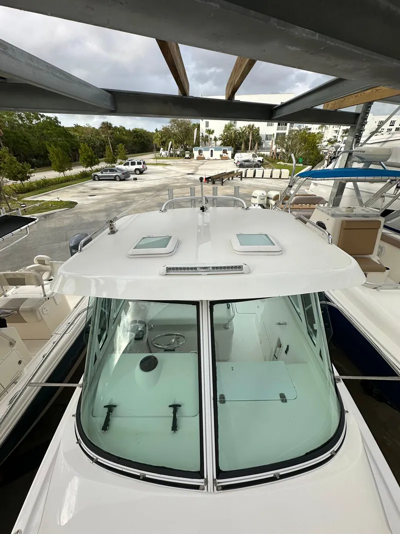 Slide: The Image of 2008 Pro-Line 26 XP boat docked, viewed from above, showcasing cabin and deck. - 29