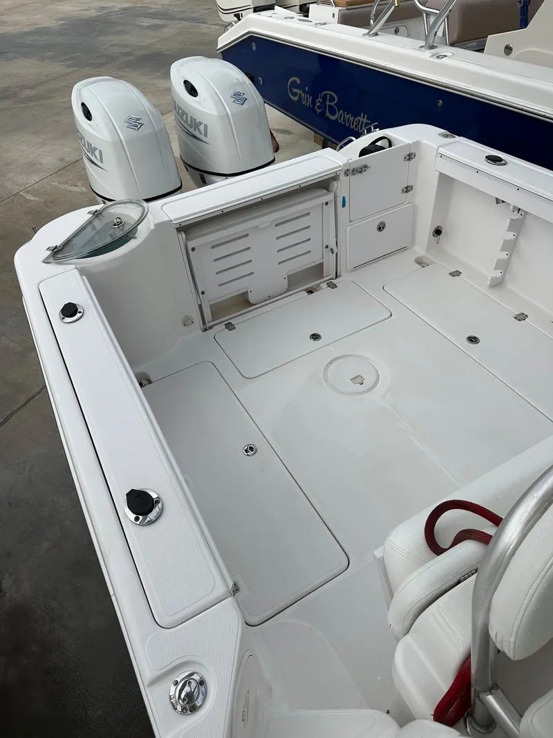 Slide: The Image of 2008 Pro-Line 26 XP boat deck with Suzuki outboard engines, featuring spacious seating and storage. - 30