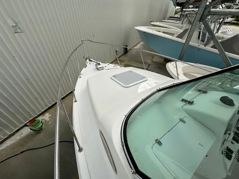 Slide: The Image of 2008 Pro-Line 26 XP boat docked, showing deck and windshield details. - 31