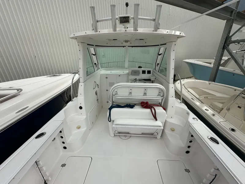 Slide: The Image of 2008 Pro-Line 26 XP boat interior with seating and control panel in storage. - 32