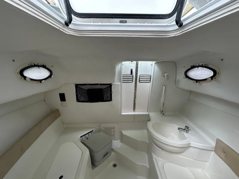 Slide: The Image of 2008 Pro-Line 26 XP boat interior with sink, toilet, and portholes. - 33