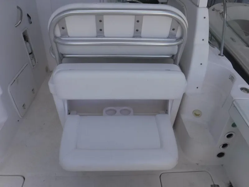 Slide: The Image of 2008 Pro-Line 26 XP boat interior with white cushioned seating and storage compartment. - 4