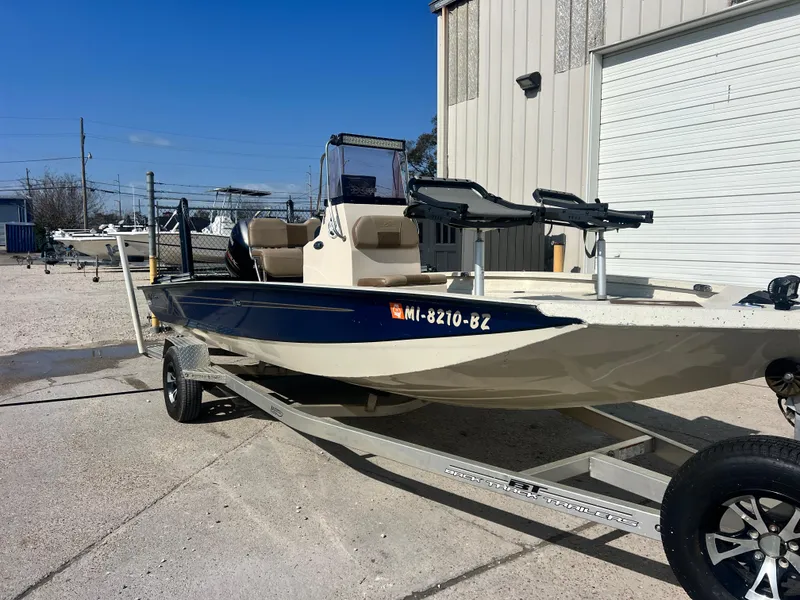 Slide: The Image of 2019 Xpress H20B boat on trailer, parked outdoors near a building. - 3