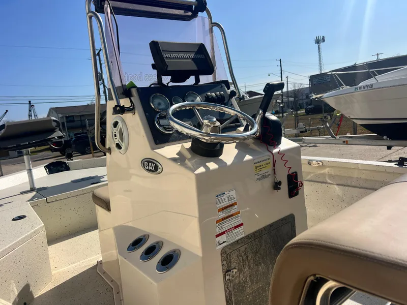 Slide: The Image of 2019 Xpress H20B boat console with steering wheel and controls in sunlight. - 5