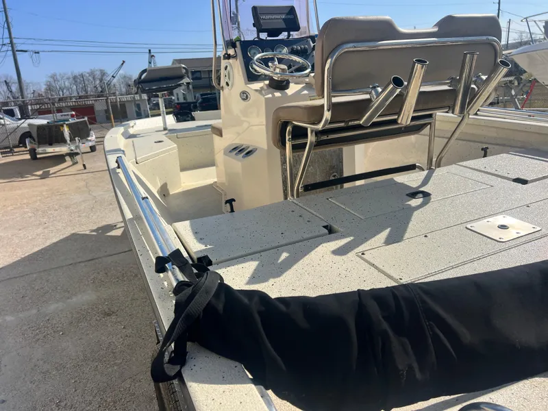 Slide: The Image of 2019 Xpress H20B boat with console and seating, parked outdoors. - 6