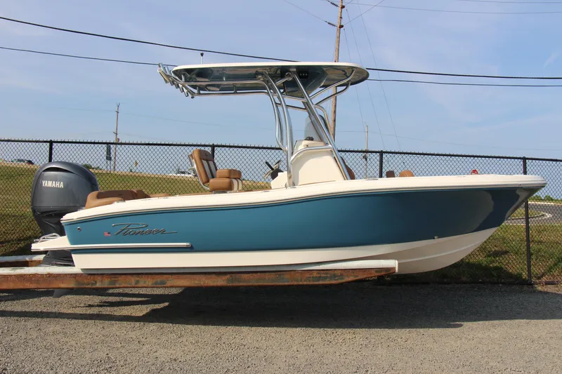 Slide: The Image of 2025 Pioneer 202 Islander boat with Yamaha engine, parked on a trailer. - 11