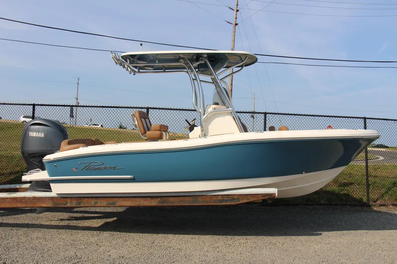 Slide: The Image of 2025 Pioneer 202 Islander boat with Yamaha engine, parked on a trailer. - 13