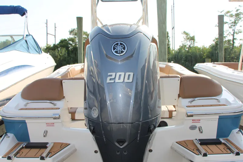 Slide: The Image of 2025 Pioneer 202 Islander boat with powerful 200 horsepower engine, docked at marina. - 14