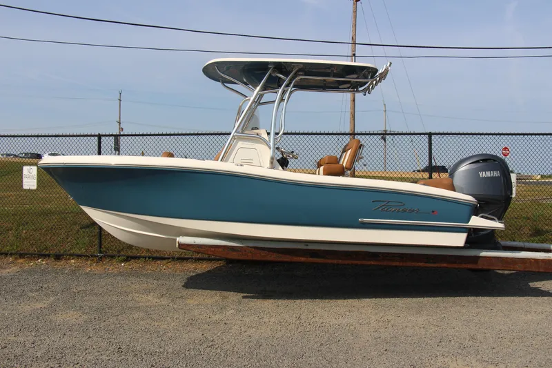 Slide: The Image of 2025 Pioneer 202 Islander boat with Yamaha engine, parked on a trailer. - 3