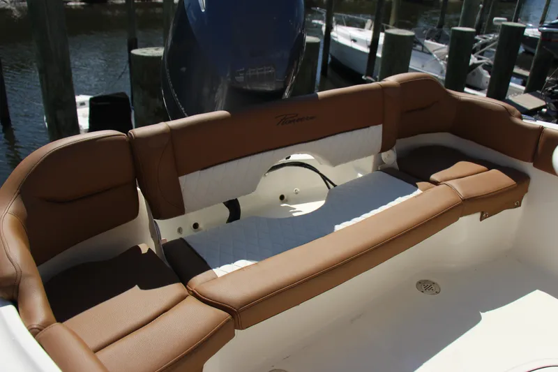 Slide: The Image of 2025 Pioneer 202 Islander boat interior with brown cushioned seating. - 4