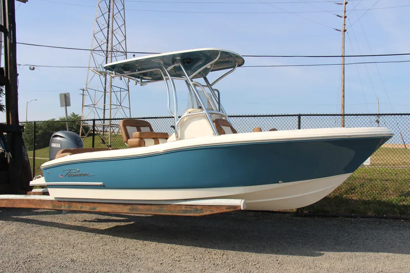 Slide: The Image of 2025 Pioneer 202 Islander boat with blue hull and Yamaha engine, displayed outdoors. - 8