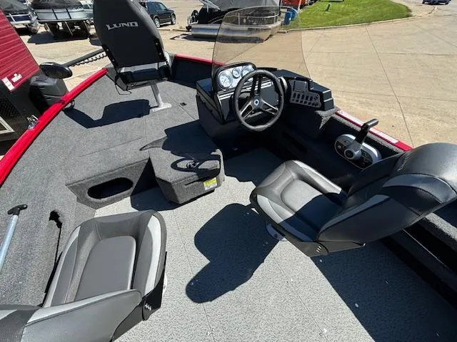 Slide: The Image of 2022 Lund 1675 Adventure SS boat interior with steering wheel and seating. - 11