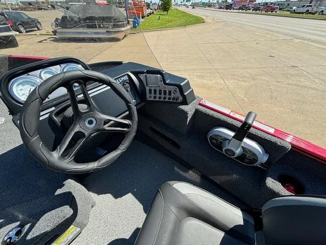 Slide: The Image of 2022 Lund 1675 Adventure SS boat dashboard with steering wheel and controls. - 12