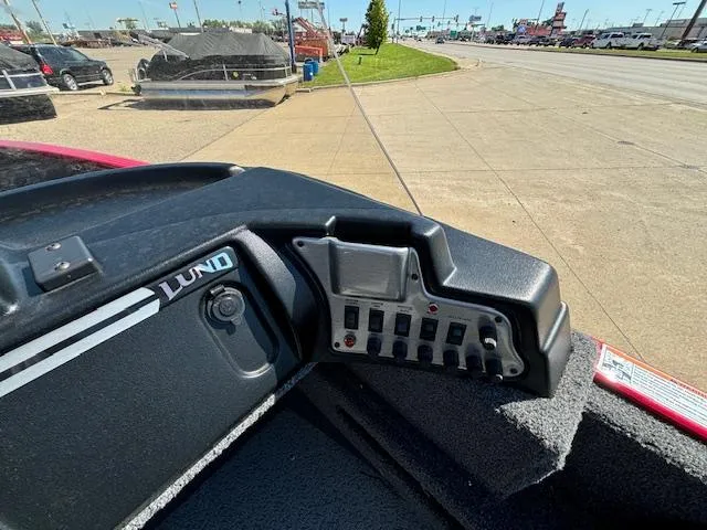 Slide: The Image of 2022 Lund 1675 Adventure SS boat dashboard with control panel and switches. - 13