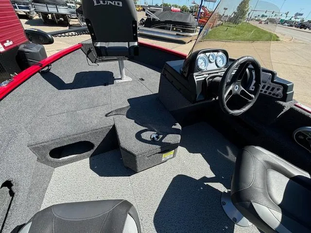 Slide: The Image of 2022 Lund 1675 Adventure SS boat interior with steering wheel and seating. - 15