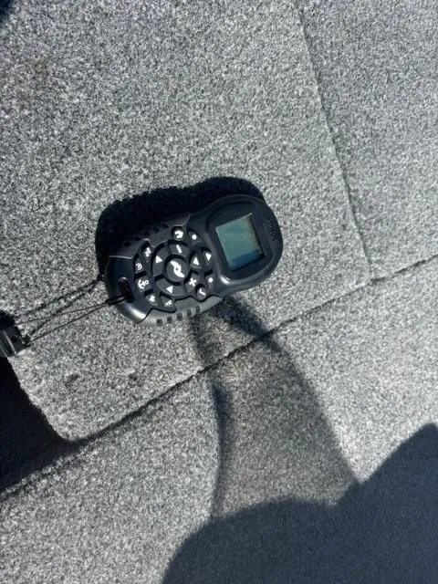 Slide: The Image of Remote control on carpeted surface of 2022 Lund 1675 Adventure SS boat. - 17