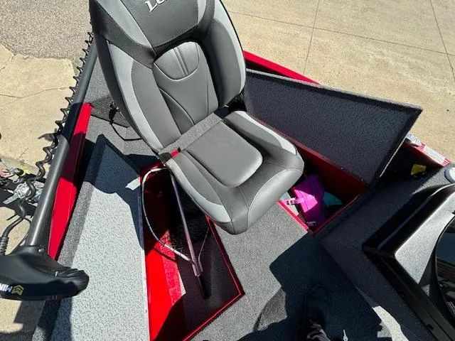 Slide: The Image of 2022 Lund 1675 Adventure SS boat interior with gray seat and open storage compartments. - 22