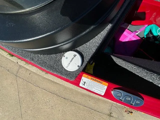 Slide: The Image of 2022 Lund 1675 Adventure SS boat interior with Minn Kota accessory and warning label. - 23