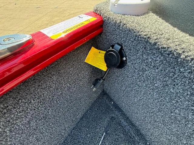 Slide: The Image of 2022 Lund 1675 Adventure SS boat interior with USB port and warning label. - 24